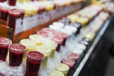 Close-up of colorful containers on ice at store