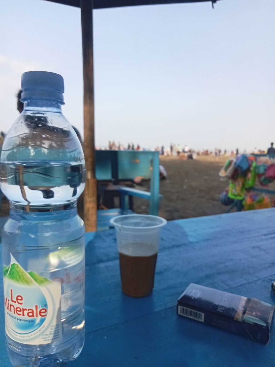 water, blue, container, bottle, bottled water, mineral water, nature, food and drink, drinking water, drink, day, table, sky, focus on foreground, water bottle, outdoors, glass, refreshment, no people, sea, business, plastic bottle, environment