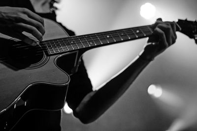 Cropped image of musician playing guitar