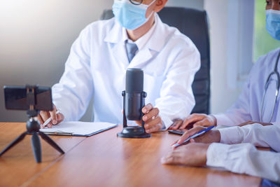 Group of doctors looking at online presentation on computer in hospital