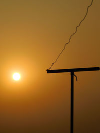 Low angle view of silhouette street light against sky during sunset