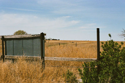House on field against clear sky