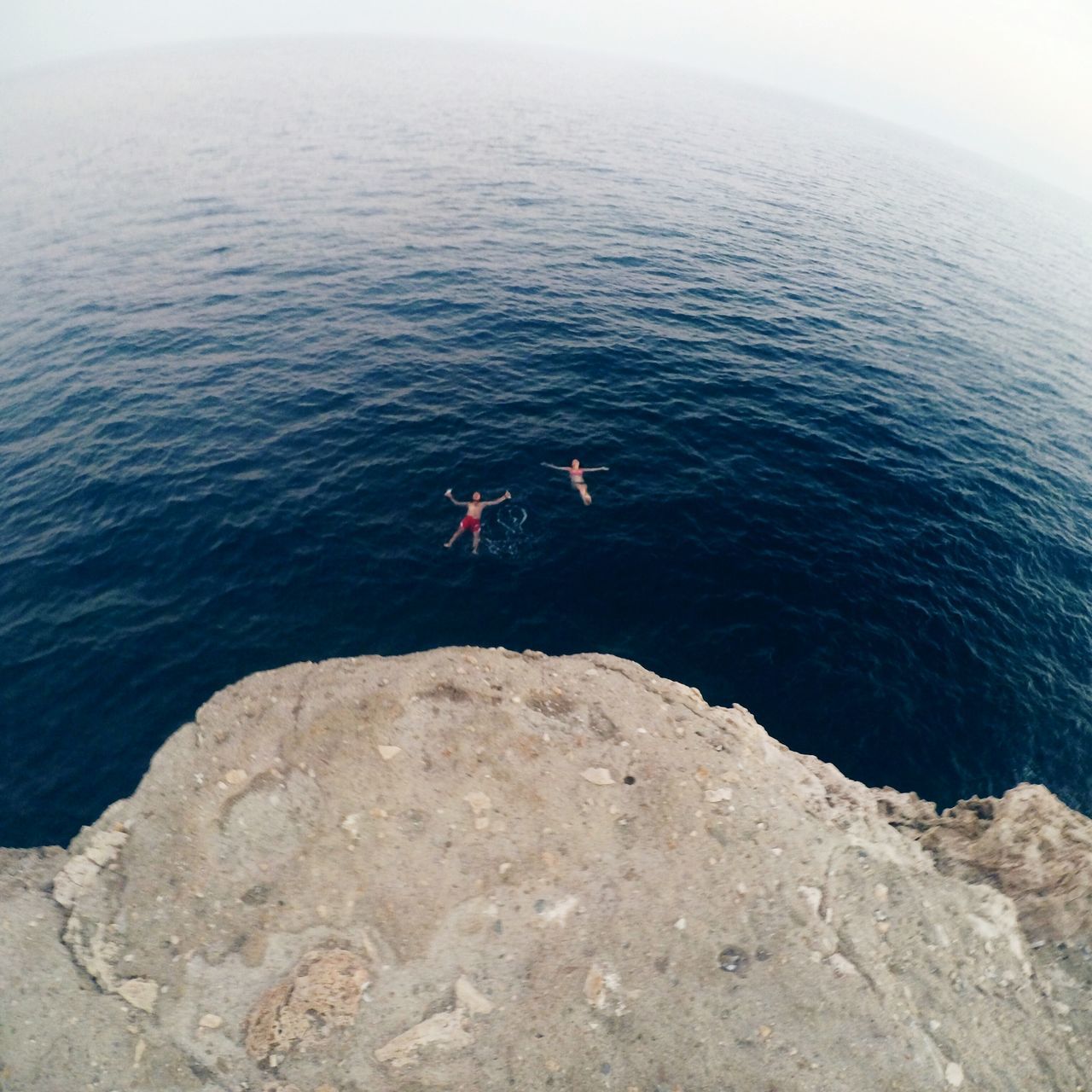 water, lifestyles, leisure activity, sea, men, rock - object, beauty in nature, tranquility, tranquil scene, nature, scenics, vacations, person, rock formation, full length, sitting, horizon over water