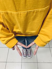 Low section of woman standing on tiled floor