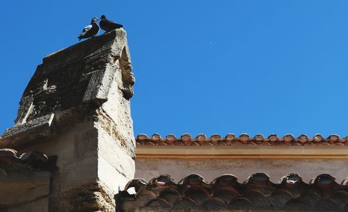 Low angle view of building against clear blue sky