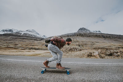 Man skateboarding on highway