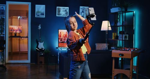 Side view of man using mobile phone while standing in factory