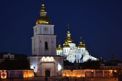 Low angle view of illuminated buildings against sky at night