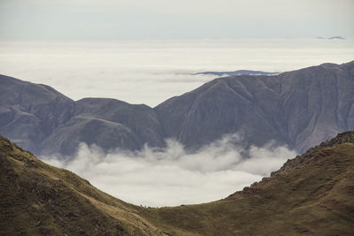 Scenic view of mountains against cloudy sky