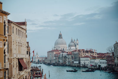 Buildings by canal in city