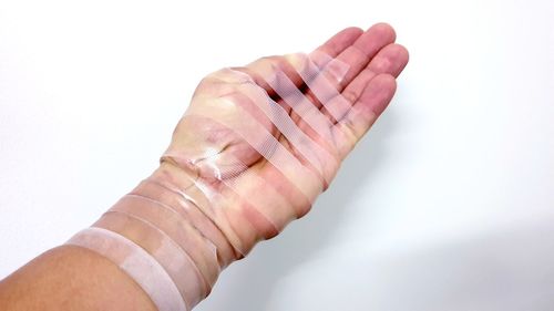 Close-up of hand against white background