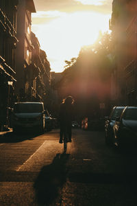 Rear view of people walking on road at night