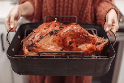 Roasted turkey on metal tray.