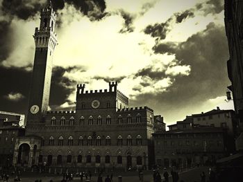 Low angle view of building against cloudy sky