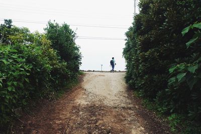 Woman walking on footpath