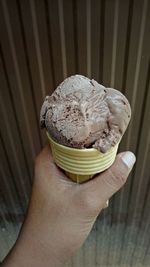 Close-up of hand holding ice cream cone