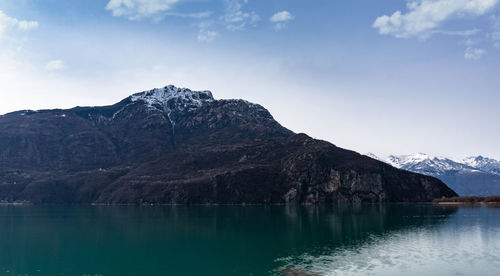 Scenic view of lake and mountains against sky