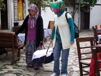 Full length of woman sitting on bench