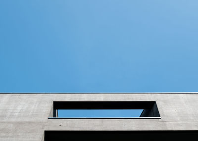 Low angle view of building against clear blue sky