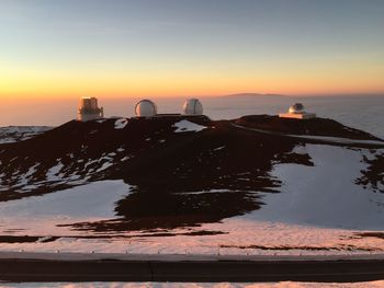 Observatory at mauna kea against sky during sunset