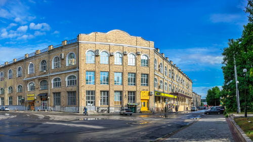 Street by building in city against sky