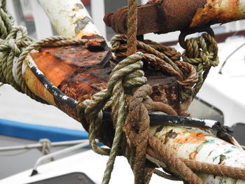 Close-up of rope tied on boat moored at harbor