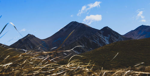 Low angle view of snowcapped mountains against sky