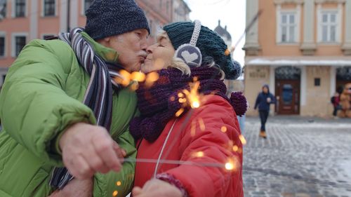 Senior couple kissing outdoors during winter