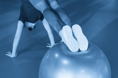 Low section of woman exercising in gym