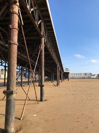 View of bridge on beach against sky