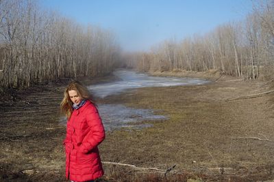 Full length of woman standing on snow covered landscape