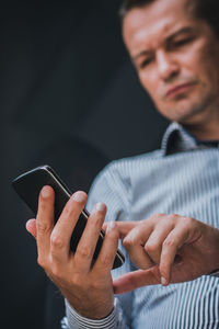 Close-up of man using smart phone.