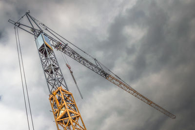 Low angle view of crane against sky