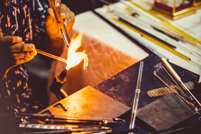 Midsection of man working in workshop