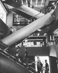 People walking on illuminated staircase in city