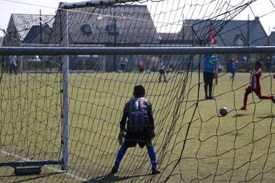 Rear view of man playing soccer