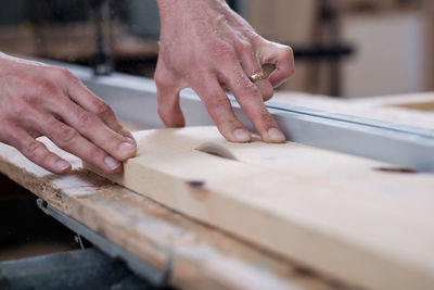 Midsection of person working on wood