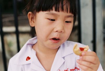 Close-up portrait of boy eating food