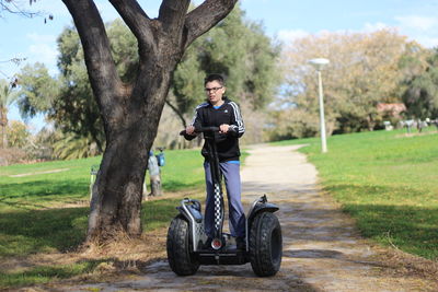 Full length of boy riding segway at park