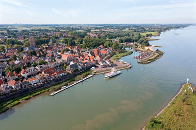 High angle view of townscape and river against sky