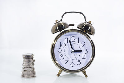 Close-up of clock over white background