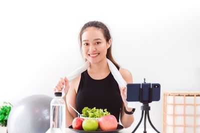 Portrait of a smiling young woman holding food