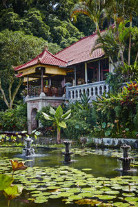 Built structure by lake against trees