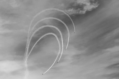 Low angle view of vapor trail against sky air show