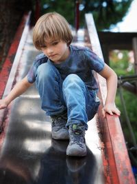 Full length of boy on slide at playground