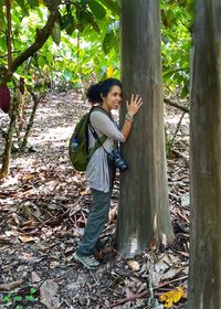 Portrait of young woman standing in forest