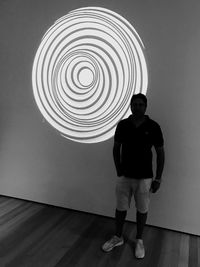 Full length of man standing against wall