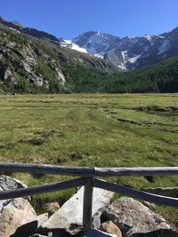 Scenic view of field and mountains against sky