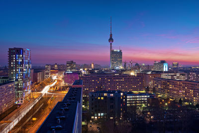 Aerial view of city lit up at night