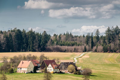 Houses on field against sky